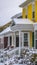 Clear Vertical Lovely houses with snowy roofs and icy yards against cloudy sky in December