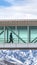 Clear Vertical Silhouette of a man walking inside a skybridge connecting buildings