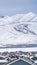 Clear Vertical Snowy rooftops of homes with a striking view of snow covered mountain in winter