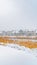 Clear Vertical Trail on the powdery snow along Oquirrh Lake with view of homes and vast sky