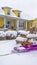 Clear Vertical Winter in Daybreak with view of a purple sled in the middle of wooden chairs