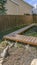 Clear Vertical Wooden walkway inside the yard of a home viewed on a sunny day