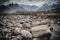 Clear water flowing through the rocks with tall mountains in the background