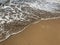 Clear water and soft sand meeting at the coastline