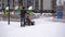Clearing snow from paths in winter. Manual diesel tractor snow purifier. Grader. The area of the courtyard of a multi