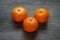 Clementines or mandarin oranges on rustic wooden table