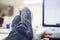 Clerk worker resting at desk with foot on table