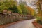 Clervaux Abbey of Saint-Maurice and Saint-Maur Benedictines old stone wall and road through the forest in Luxembourg