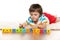 Clever boy with blocks on the carpet