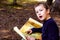 A clever boy searches an ancient map for something buried in a forest