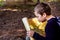 A clever boy searches an ancient map for something buried in a forest