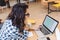 Clever pretty student at studying with laptop in university library. Attractive young woman at work, freelancer, surfing