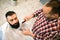 Client during beard and moustache grooming at barber shop