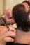 Client during beard shaving in barbershop beauty