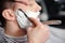 Client shaving at barber shop