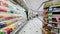 Clients choose fresh yogurts on large display in supermarket