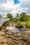 Clifden waterfalls on the Owenglin or Owenglen river with the old Ardbear bridge in the background