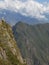 Cliff, clouds and mountains