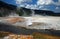Cliff Geyser next to Iron Spring Creek in Black Sand Geyser Basin in Yellowstone National Park in Wyoming USA