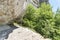 Cliff in high Caucasian mountains, footpath in rocks.