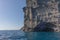 Cliff of the island of santorini with boats to sail.