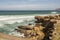 Cliff with loose rocks and persistent waves on the Portuguese Atlantic coast