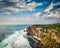 Cliff in ocean on sunset