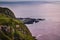 Cliff at sunset with shrubs and hot sea springs of Ponta da Ferraria in lava fajÃ£ in the Atlantic Ocean, SÃ£o Miguel - Azores