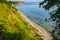 Cliff with vegetation above idyllic and peaceful bay