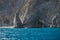 Cliffs with caves surrounding Domata beach, a view from ferry ona way between Agia Roumeli and Sougia, south-west of Crete island