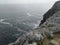 Cliffs hang over the sea.