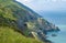 Cliffs and hillside in Wicklow, Ireland. Irish sea on right and railway tunnels visible in cliffside