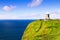 Cliffs of Moher and O`Brien`s tower, west coast of Ireland, County Clare at wild atlantic ocean.