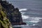 Cliffs with moss by the sea and seabirds in the coastal