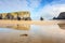 cliffs reflecting on wet sand at low tide