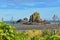 Cliffs and rock formations along black sand Whatipu Beach in Huia