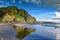 Cliffs and rock formations along black sand Whatipu Beach in Huia