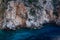 Cliffs of the seashore of the Greek island of Corfu in the deep blue water