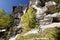 Cliffs surrounded by greenery under a deep blue sky