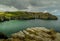 Clifftop view of Bossiney Cove at high tide.
