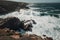 clifftop view of crashing waves and rocky shoreline