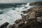 clifftop view of crashing waves and rocky shoreline