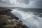 clifftop view of crashing waves and stormy sky