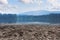 Climate change and global warming concept. Dry lake and drought land with forest and blue sky with white clouds landscape