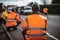 Climate change protest activists wearing hi vis jacket sit on a road and block traffic