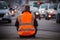 Climate change protest activists wearing hi vis jacket sit on a road and block traffic