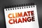 Climate change - refers to long-term shifts in temperatures and weather patterns, text concept on notepad