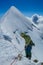 Climber abseiling or rappelling from the snow mountain