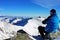 Climber admiring the view from Peleaga peak in Retezat mountains, Romania