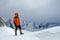 Climber alpinist stands on the top of the mountain. Snowy peaks and sky, Altai, Belukha